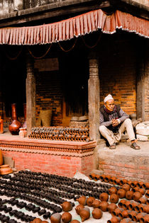 A vendor in Bhaktapur Pottery Square. by Tom Hanslien