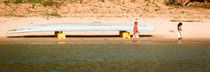 Kids playing along the Mekong River. by Tom Hanslien