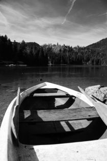 Boat on alpine lake by Falko Follert