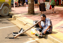 A busker playing a didgeridoo in Australia by Chris Edmunds