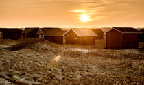 Beach cabins in sunset by Mike Santis