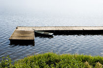 Single dilapidated boat moored by Arletta Cwalina