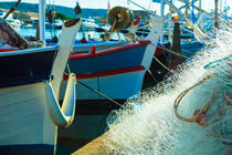 fishing net and boat at the harbor  by Leandro Bistolfi