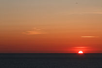 Sun setting into the atlantic ocean by Chris Warham