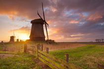 Traditional Dutch windmills at sunrise in The Netherlands by Sara Winter