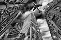  A jet plane flying over the city by Bombaert Patrick