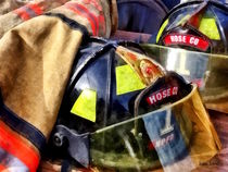Two Fire Helmets And Fireman's Jacket von Susan Savad