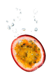 Passion fruit in water with air bubbles by Bastian Linder