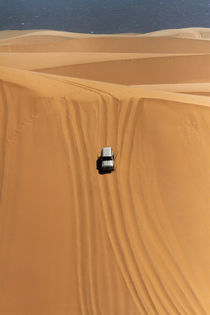 Four wheel drive descending a huge sand dune on a Sandwich H... von Danita Delimont