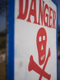Skull and crossbones danger sign, Udaipur, Rajasthan, India. by Danita Delimont