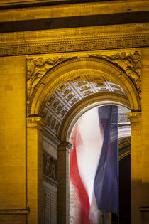 Flag flies inside the Arc de Triomphe, Paris, France. by Danita Delimont