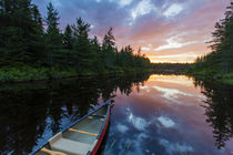 A canoe at sunrise on Little Berry Pond in Maine's Northern Forest von Danita Delimont