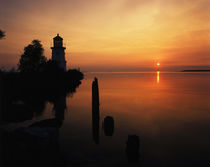 USA, Michigan, Cheboygan, View of sea and lighthouse at sunset by Danita Delimont