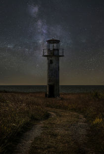 An old lighthouse at night by Jarek Blaminsky