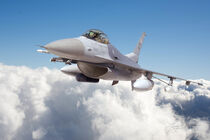 F-16 Above The Clouds by Larry McManus