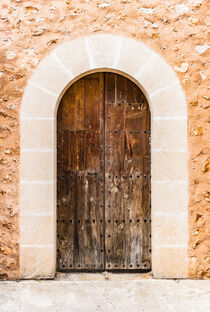 Brown old wooden front door of mediterranean house entrance  by Alex Winter