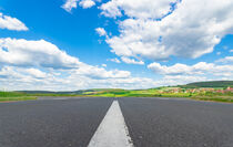 Asphalt Road scenery with sunny blue cloudy sky by Alex Winter