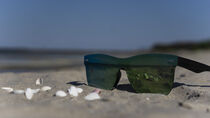 sunglasses on sand by kristynes