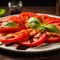 Olli77-fresh-sliced-red-tomatoes-with-balsamic-vinegar-and-basi-0cbff643-ab38-41c3-8719-e3fb95f4fe90