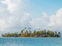 Island with palm trees, scenic sky and clear water by oh aniki