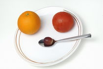 Plate and spoon with one Orange, one tomatoe, one grape, on white background by Sami Sarkis Photography