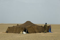 Nomad walking outside tent in the desert, Sahara, Morocco by Panoramic Images