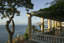 Group of people sitting in a restaurant by the sea by Panoramic Images