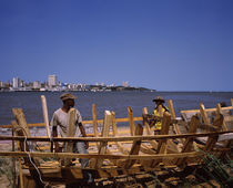 Two men making a boat at the coast, Delagoa Bay, Maputo, Mozambique by Panoramic Images