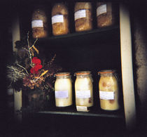 Jars and flowers in racks von Panoramic Images