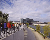 Group of people walking on a footpath along a river by Panoramic Images
