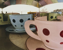 Tea cup ride in an amusement park by Panoramic Images