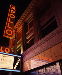 Low angle view of a theatre lit up at night by Panoramic Images