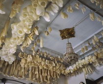 Low angle view of doll parts hanging from a ceiling, Salvador, Brazil von Panoramic Images