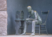 Bronze statue of a man listening to radio during great depression by Panoramic Images