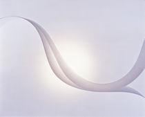 Two white fabric streamers drifting in pale grey sky with strong backlight by Panoramic Images