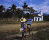 Man painting a church on the roadside by Panoramic Images