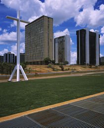 Cross in front of buildings in a city, Brasilia, Brazil by Panoramic Images