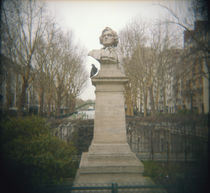 Pigeon beside a bust in a park, France by Panoramic Images