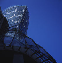 Low angle view of a glass building by Panoramic Images