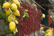 Close-up of lemons and chili peppers in a market stall by Panoramic Images