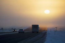 Sunrise over highway traffic, winter fog. von Panoramic Images