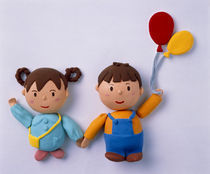 Cartoonish boy and girl holding hands boy holding balloons von Panoramic Images