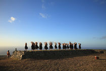 Hula dancers performing on the beach at sunrise, Molokai, Hawaii, USA by Panoramic Images