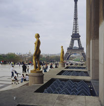 Gilded statue of a woman with a tower in the background by Panoramic Images