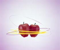 Two floating red apples surrounded by yellow rings von Panoramic Images