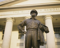 Low angle view of a statue in front of a building by Panoramic Images