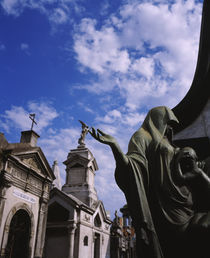 Low angle view of a statue in a cemetery by Panoramic Images