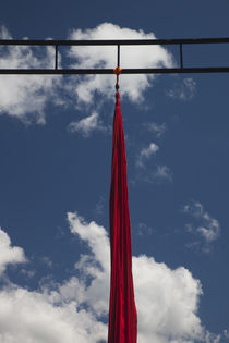Red silk textile hanging for acrobatic performance by Panoramic Images