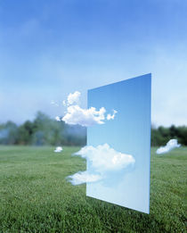 White clouds passing through a pale blue horizontal of sky with green grass von Panoramic Images