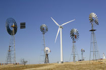Traditional windmills with a wind turbine on a landscape von Panoramic Images